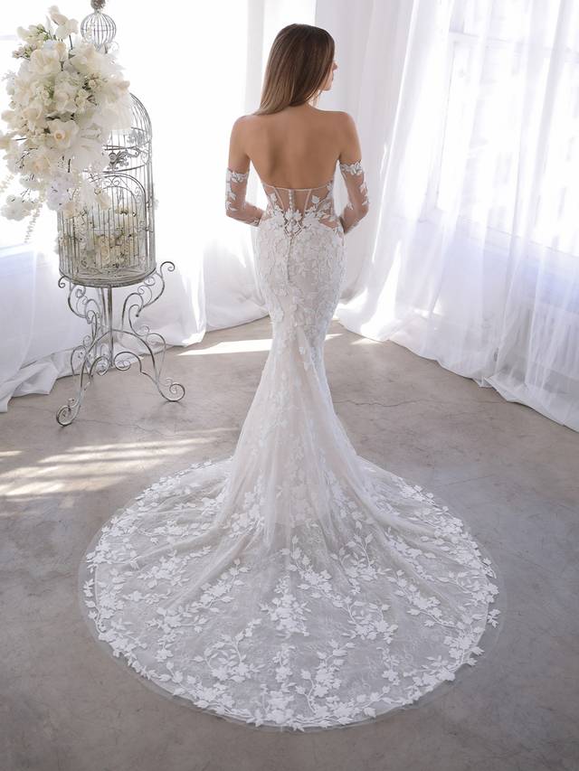Code: Blue By Enzoani Orrie (with sleeves) Code: Blue By Enzoani Orrie (with sleeves) Orrie is the answer for our brides who love the Naroza but want the option to completely remove the long off-shoulder sleeves. Our beloved thick embroidered floral lace is front and center on this gown with a deep sweetheart neckline and eye-catching illusion corset-style back with covered buttons. Colour Options: Ivory/Sand/Nude OR Ivory/Ivory/Nude OR Ivory/Nude/Nude OR Ivory/Ivory/Ivory