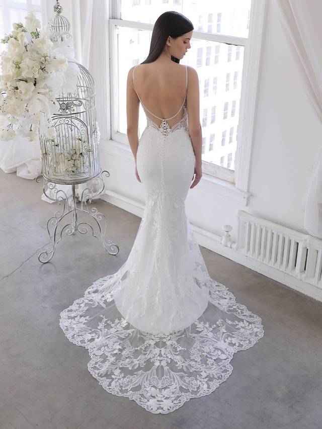 Code: Enzoani Blue Omari Code: Enzoani Blue Omari Delicate, dreamy, dramatic – Omari is perfect for the modern bride who wants both exquisite detailing and unique versatility. Intricate floral embroidered lace travels from the romantic sweetheart neckline bodice and low illusion back down to the soft and sleek stretch georgette skirt. The gorgeous scalloped lace hem easily connects to the detachable lace train extension for that extra glam option for the ceremony. Colour Options: Ivory/Nude OR Ivory/Ivory