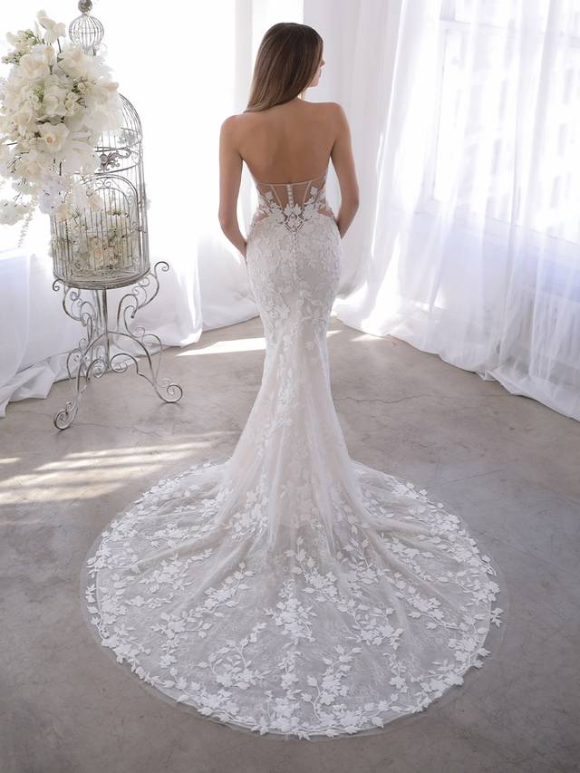 Code: Enzoani Blue Orrie Code: Enzoani Blue Orrie Orrie is the answer for our brides who love the Naroza but want the option to completely remove the long off-shoulder sleeves. Our beloved thick embroidered floral lace is front and center on this gown with a deep sweetheart neckline and eye-catching illusion corset-style back with covered buttons. Colour Options: Ivory/Sand/Nude OR Ivory/Ivory/Nude OR Ivory/Nude/Nude OR Ivory/Ivory/Ivory