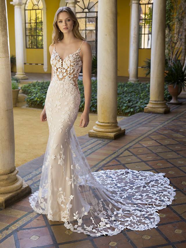 Code: Blue By Enzoani Petal Code: Blue By Enzoani Petal Like a gorgeous upgrade on our beloved Lesley gown. The intricate custom-made thick cotton embroidered floral motifs are the center of this curve-hugging mermaid gown as they cover every inch. And it stands out even more with figure-enhancing side panels and a plunging illusion sweetheart neckline bodice with sweet spaghetti straps. The illusion embellished back is sure to keep all eyes on the bride, especially with the lace appliques beautifully cascading down the lavish skirt, featuring a signature Enzoani scalloped lace train.Colour Options: Ivory/Nude/Nude OR Ivory/Ivory/Nude OR Ivory/Ivory/Ivory OR Ivory/Sand/Nude