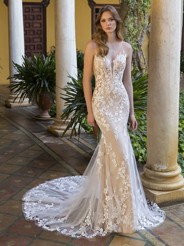 Code: Blue By Enzoani Pierce Code: Blue By Enzoani Pierce Angelic & divine… Meet our Pierce. This figure-enhancing wedding gown features a beaded cotton lace all over with sexy illusion straps and an unforgettable plunging neckline. Not only does this lacy goddess feature sparkling tulle, but she also includes striking side panels for added glamour.Colour Options: Ivory/Nude/Nude OR Ivory/Ivory/Nude OR Ivory/Ivory/Ivory OR Ivory/Sand/Nude