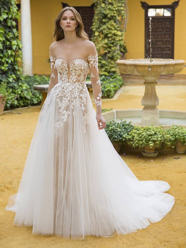 Code: Enzoani Blue Phoenix Code: Enzoani Blue Phoenix This magical bridal dream will have your guests mesmerized with the all-over sequin tulle paired with embroidered lace. This A-line showstopper includes a beaded nude illusion jacket that may be removed while you dance into the night. Adding a touch of sexiness, the corset styled back perfectly pairs with the romantic tulle skirt. This versatile wedding dress is ready to be worn in any season.Colour Options: Ivory/Beige/Nude OR Ivory/Ivory/Ivory OR Ivory/Ivory/Nude
