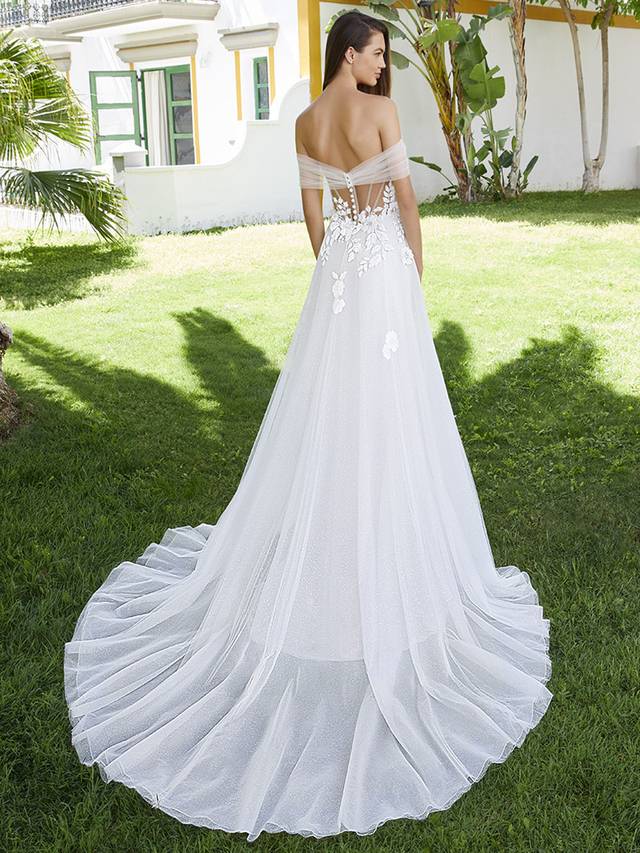 Code: Love By Enzoani Bernadine Code: Love By Enzoani Bernadine BERNADINE effortlessly exudes romance. The soft sweetheart neckline is elegantly balanced with dreamy off-the-shoulder tulle sleeves, a sexy illusion corset style bodice with exposed boning and delicately scattered floral embroidered lace that drapes onto an ethereal glitter tulle skirt. The tulle draping detail across the appliques adds even more eye-catching flair to this uniquely sweet and modern gown. Colour Options: Ivory/Beige/Nude OR Ivory/Ivory/Ivory OR Ivory/Ivory/Nude