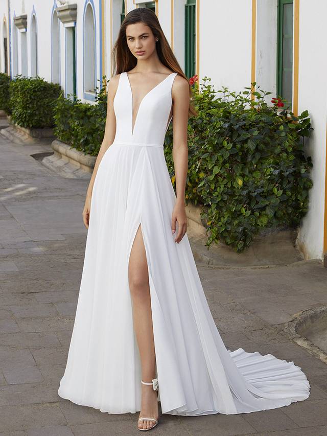 Code: Love By Enzoani Bree Code: Love By Enzoani Bree Float down the aisle in Bree, a soft, layered chiffon, A-line dream. A sweet, thin belt, plunging illusion neckline and illusion side cut-outs cinch the waistline and beautifully accentuate the curves for a modern spin on a classic, romantic silhouette. For an added touch of drama, Bree features a sexy front slit. We can’t get enough! Colour Options: Ivory