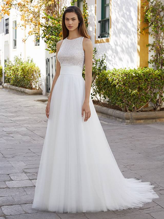 Code:Love By Enzoani Brystol-A Code:Love By Enzoani Brystol-A Who says the bride has to wear a one-piece gown? Brystol-A gives a girl choice! Glisten like no other in this beautifully beaded, cropped style bodice, complete with clear buttons for a sexy touch.Brystol-A’s soft tulle, A-Line skirt features a wide waist band that cinches and flatters the figure for a super chic two-piece bridal look.Colour Options: Ivory/Nude OR Ivory/Ivory