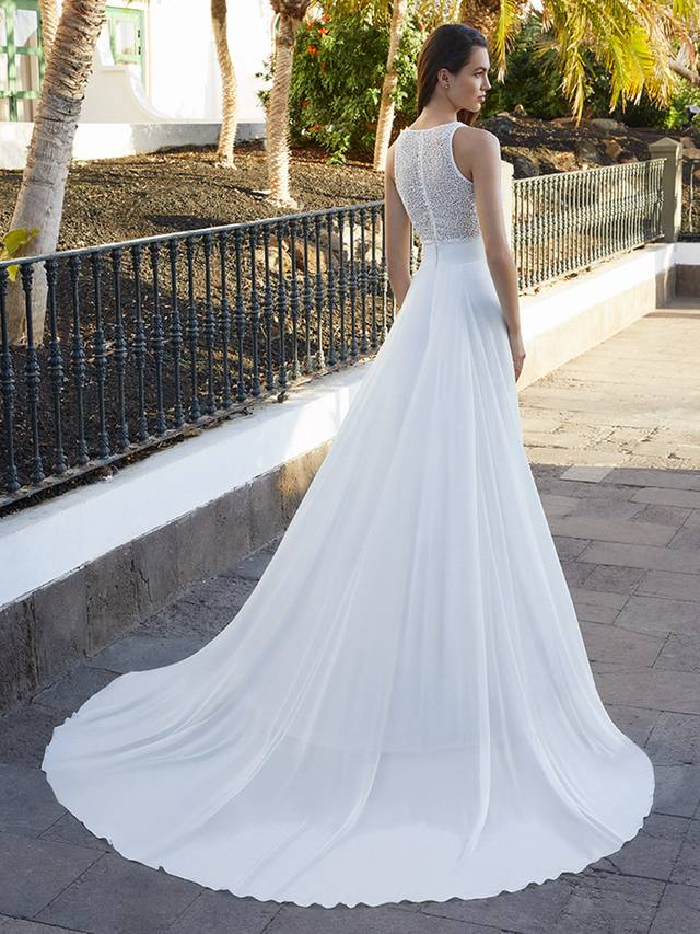 Code: Love By Enzoani Brystol-B Code: Love By Enzoani Brystol-B Who says the bride has to wear a one-piece gown? Brystol-B gives a girl choice! Glisten like no other in this beautifully beaded, cropped style bodice, complete with clear buttons for a sexy touch.Captivate with the soft, lightweight chiffon skirt that effortlessly falls into an understated sweeping train.Colour Options: Ivory/Nude OR Ivory/Ivory